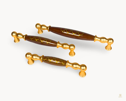 Angled view of Belmira gold drawer handles with dark brown porcelain and Golden Tile pattern in multiple sizes