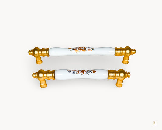 Eloura gold porcelain drawer handles featuring Golden Arch Bloom motif, front view showing classic luxury design