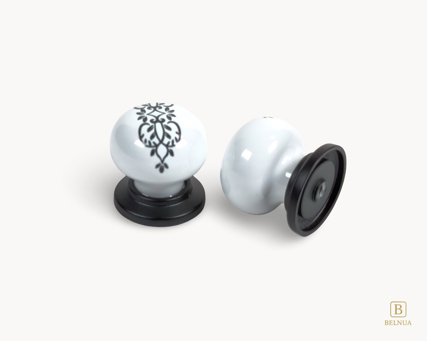 Belnua - Two white ceramic ZERRA knobs with black decorative patterns on a white background, with top and back view