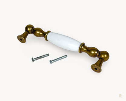 Belmira antique brass porcelain handle showing underside and fixing screws, 128mm centre to centre