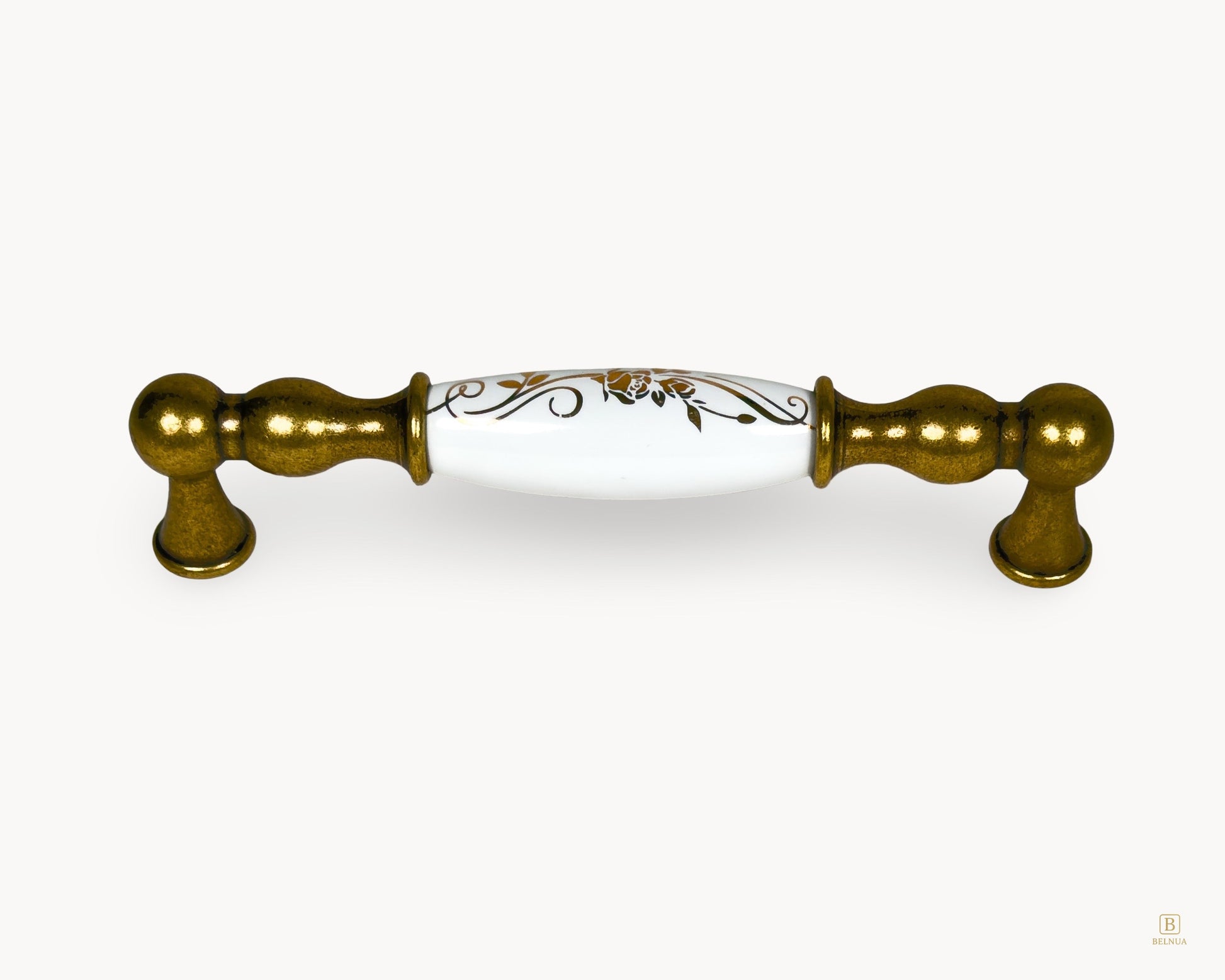 Belmira antique brass cabinet handle with white porcelain insert and golden scroll motif, 128mm centre to centre