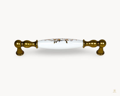 Belnua Belmira antique brass handle with white porcelain insert and golden scroll motif, 160mm centre to centre
