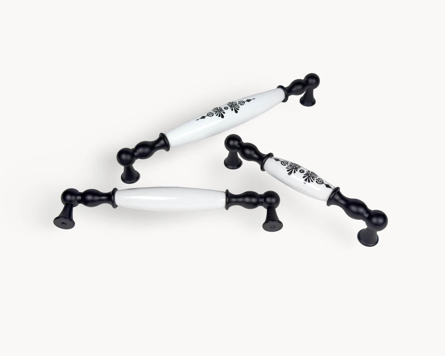 Belmira black porcelain cabinet handles with Midnight Blossom design photographed on a clean white background.