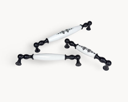 Belmira black porcelain cabinet handles with Midnight Blossom design photographed on a clean white background.