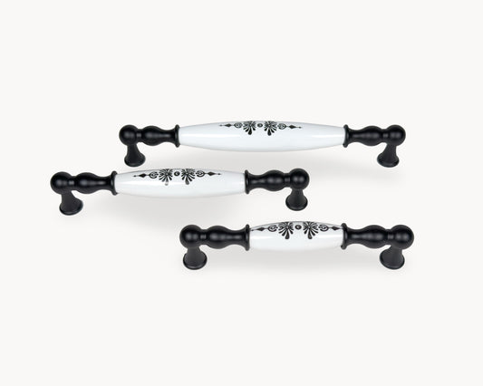 Belmira black cabinet handles with white porcelain inserts featuring the Midnight Blossom motif, shown together in 128mm, 160mm and 192mm sizes.