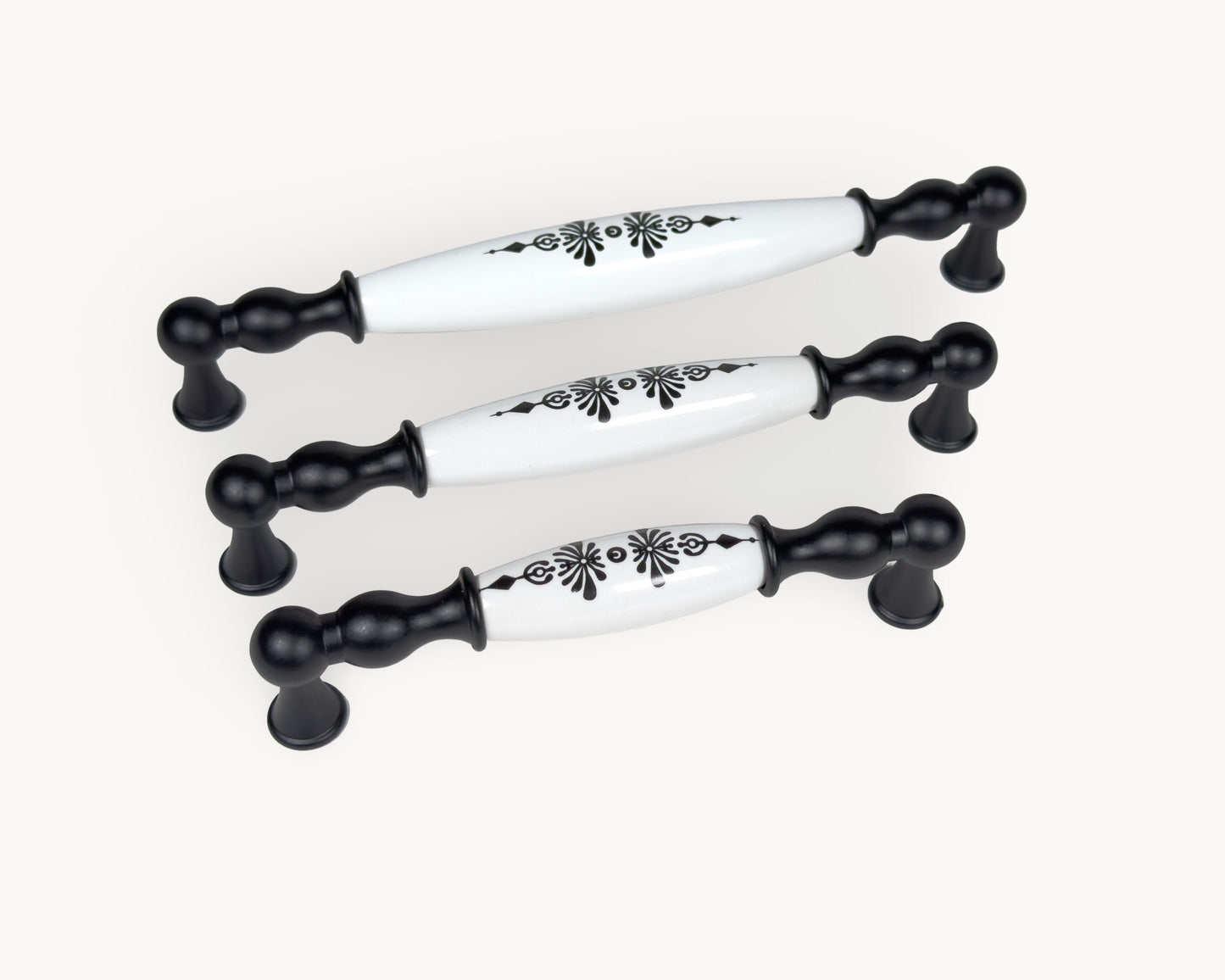 Horizontal layout of Belmira black porcelain handles with Midnight Blossom motif in three size options.