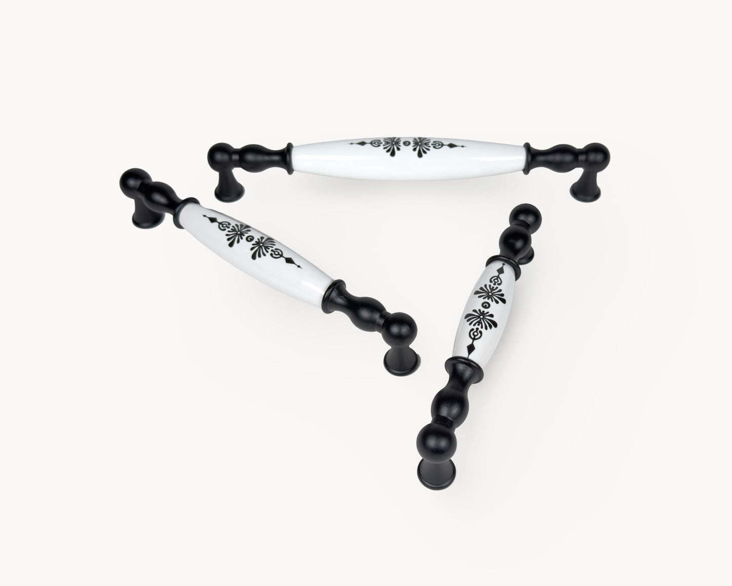 Perspective view of Belmira black porcelain handles displaying the Midnight Blossom motif across multiple sizes.