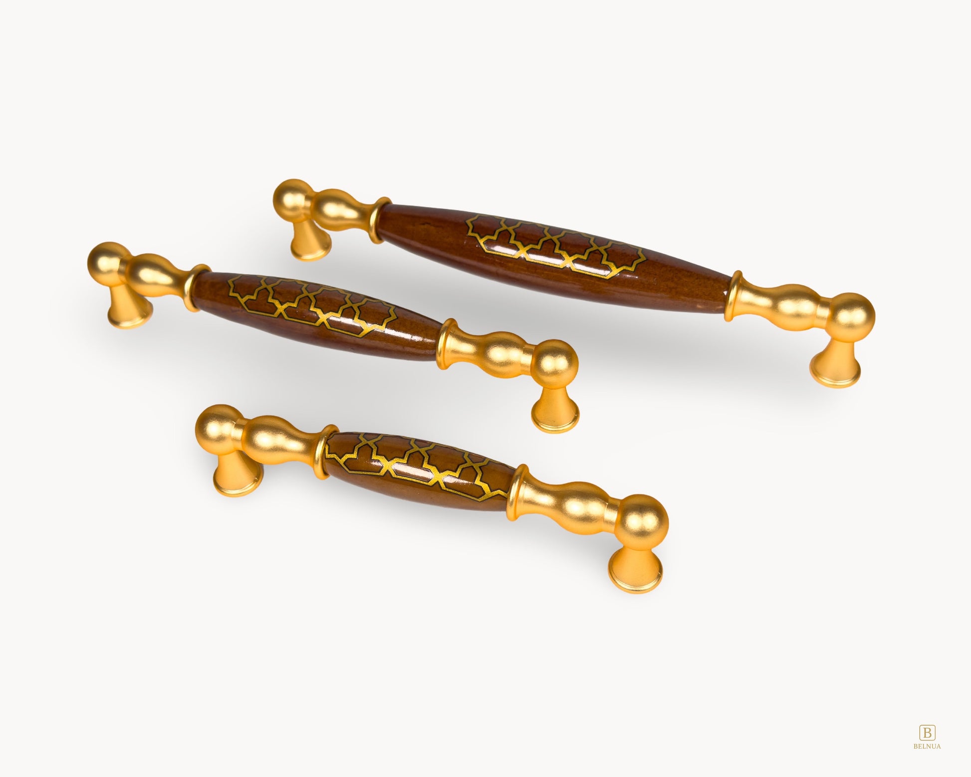 Angled view of Belmira gold drawer handles with dark brown porcelain and Golden Tile pattern in multiple sizes