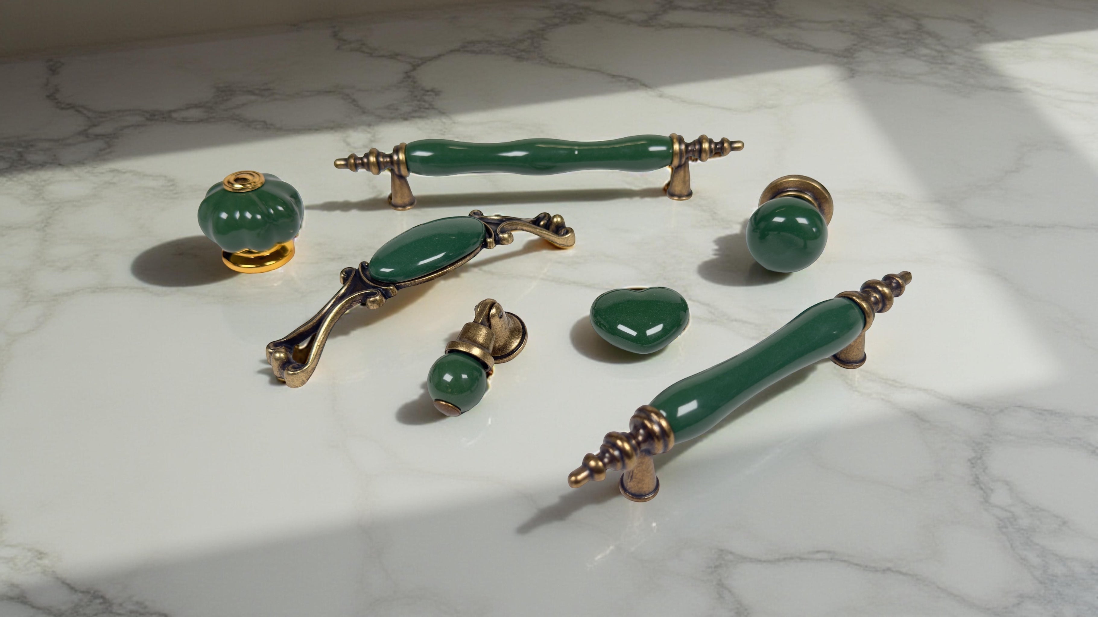 Dark green porcelain handles and knobs from Belnua’s Velnoa, Nureya, Virella, Zerra and Tavira collections, crafted with antique brass hardware for luxury cabinets.