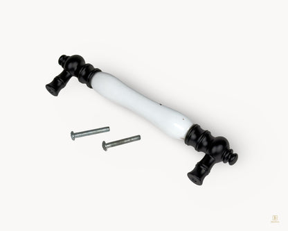 Eloura black porcelain 128mm cabinet handle shown with fixing screws included for installation