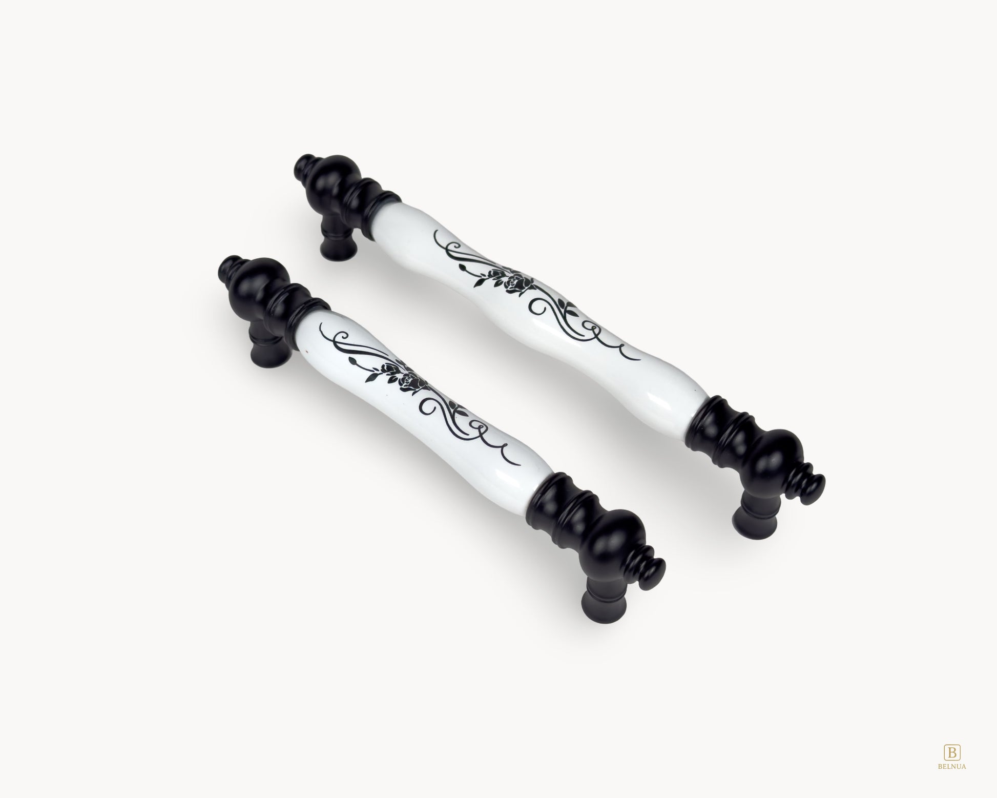Eloura black porcelain handles shown together in angled view with botanical porcelain detailing
