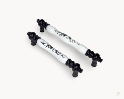 Eloura black porcelain handles shown together in angled view with botanical porcelain detailing