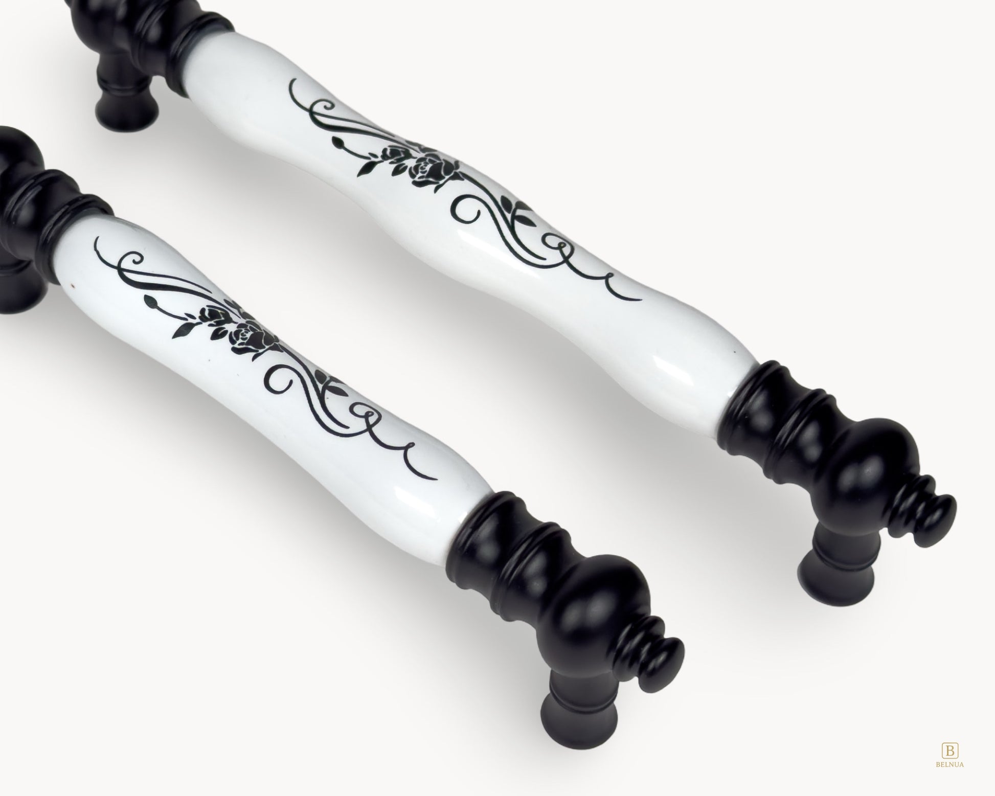 Close-up of Eloura porcelain handle showing black floral botanical motif