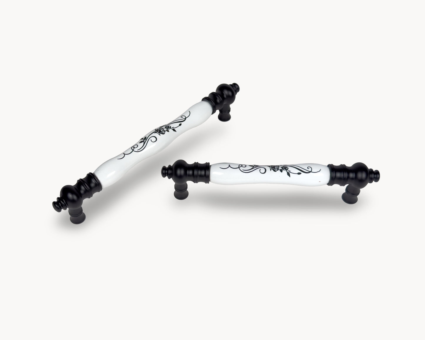 Eloura black porcelain cabinet handles styled together on light background