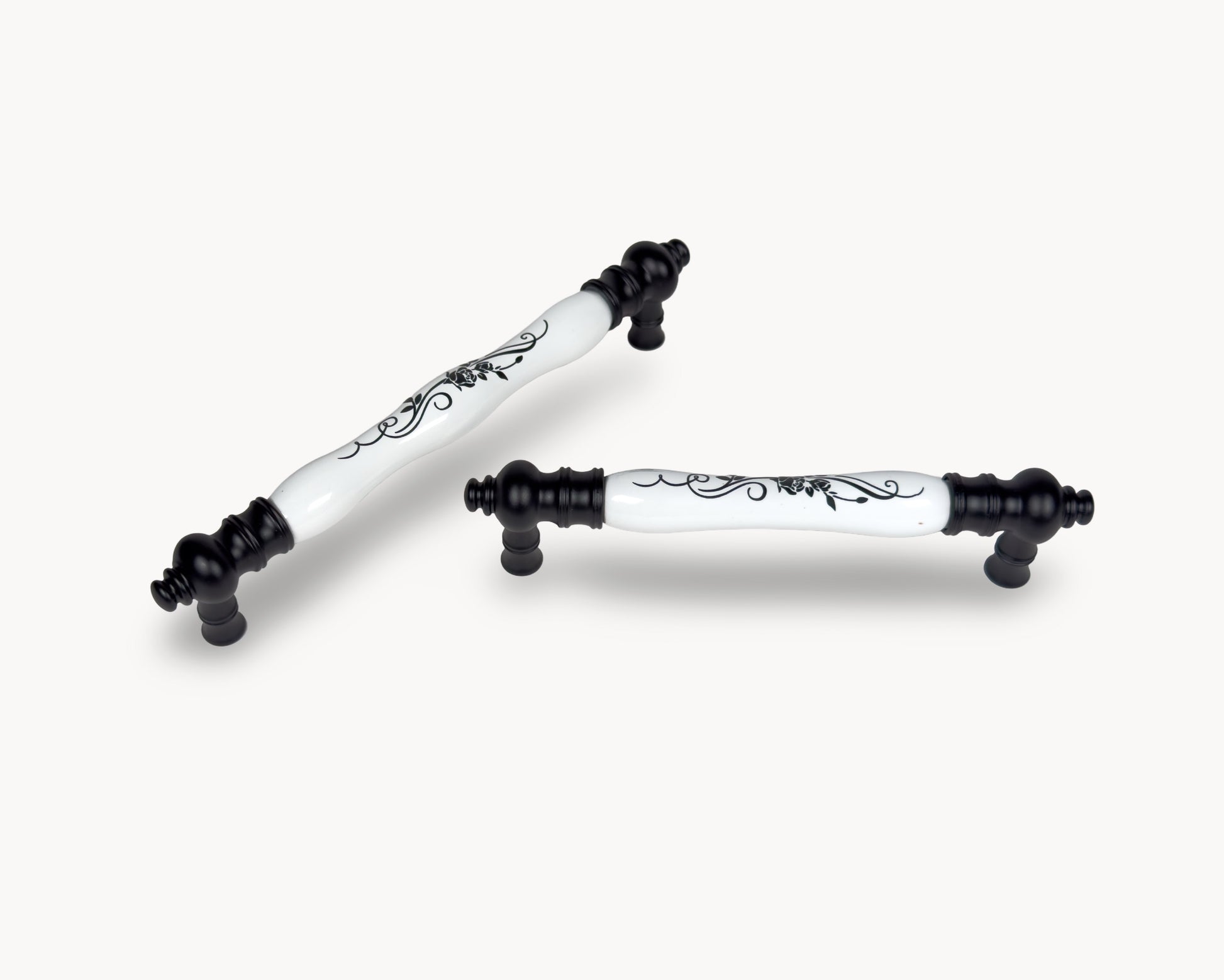 Eloura black porcelain cabinet handles styled together on light background