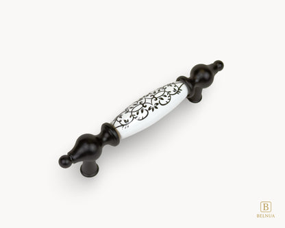 Angled view of Lumora black porcelain cabinet handle 96mm with matte black base