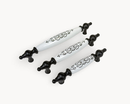 Belnua Lumora black porcelain cabinet handle collection showing 96mm, 128mm and 160mm sizes with floral detail