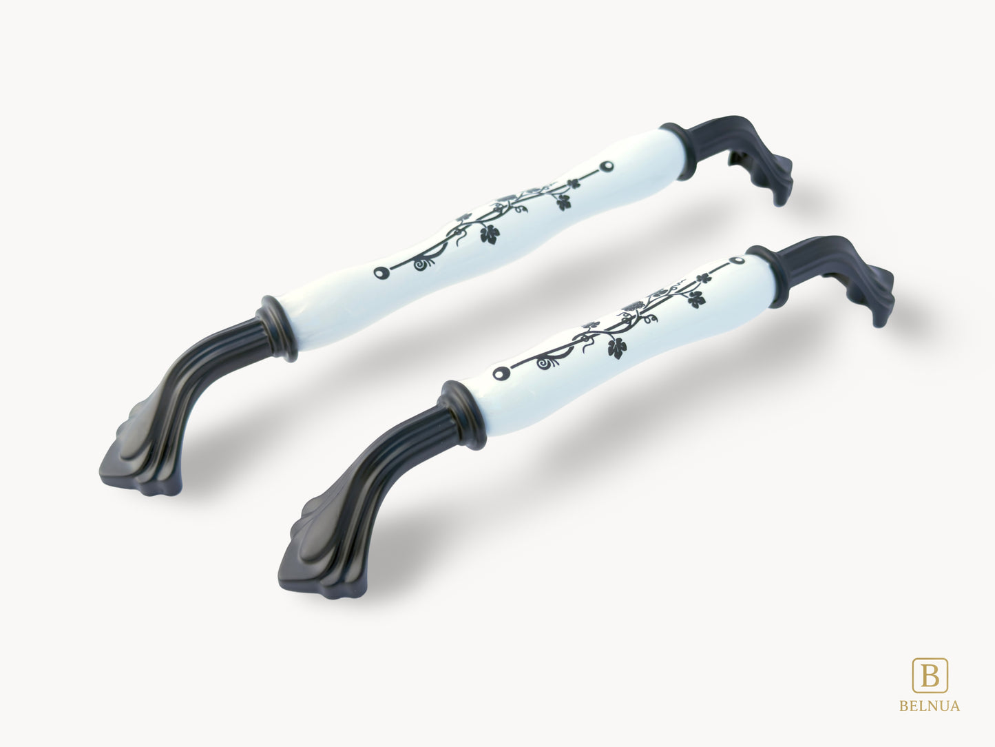 Belnua - Left angled view of Rosmira decorative matte black handle pair with black leaf motif on white porcelain