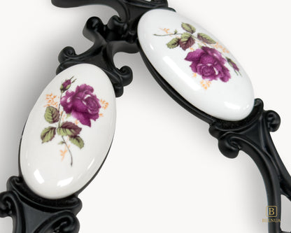 Belnua - Closeup view of white porcelain rose motif drawer pull handle from Nureya collection with balck base 