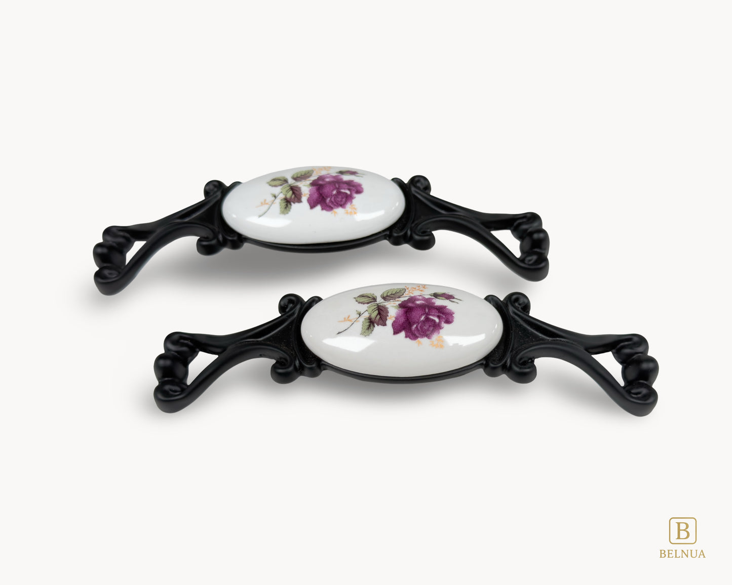 Belnua - Flatlay view of Nureya cabinet pull handle with balck metal base featuring rose motif on white ceramic/porcelain