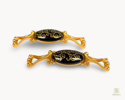 Belnua- Two decorative pulls with gold frames and black porcelain with golden scroll motif from Nureya collection