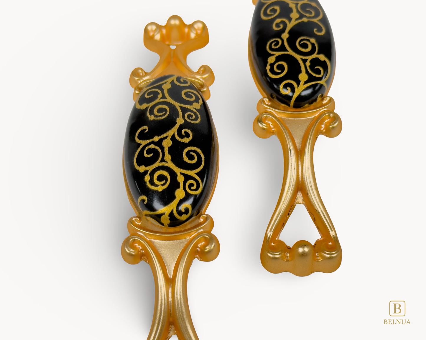 Belnua - Closeup view of Nureya black porcelain pull handle with golden scroll motif
