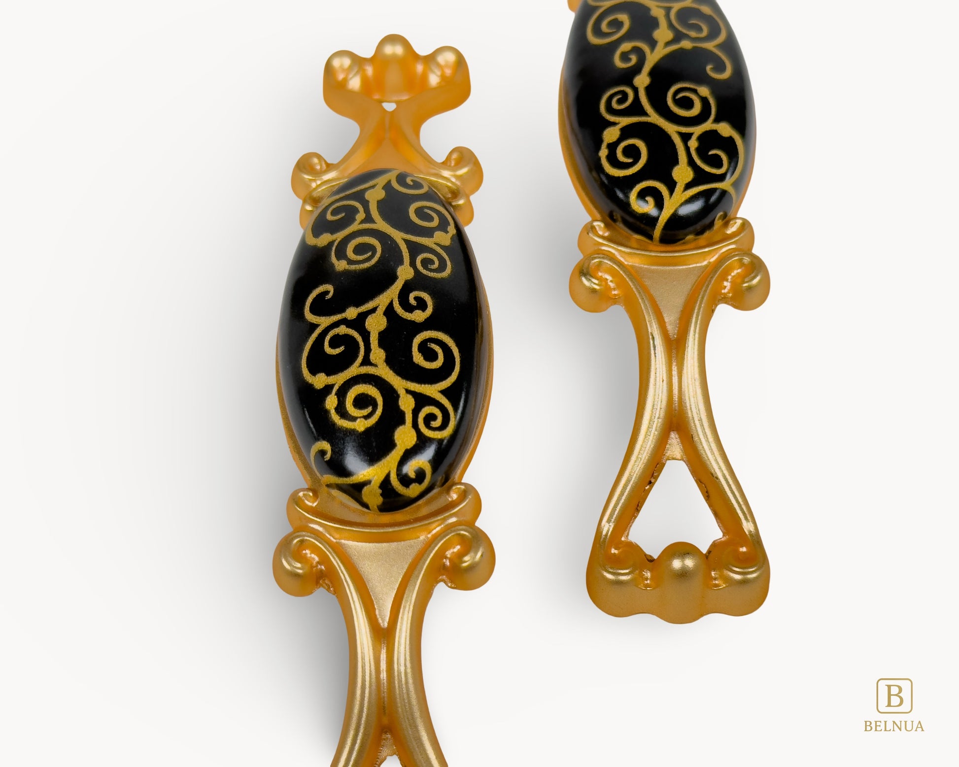 Belnua - Closeup view of Nureya black porcelain pull handle with golden scroll motif