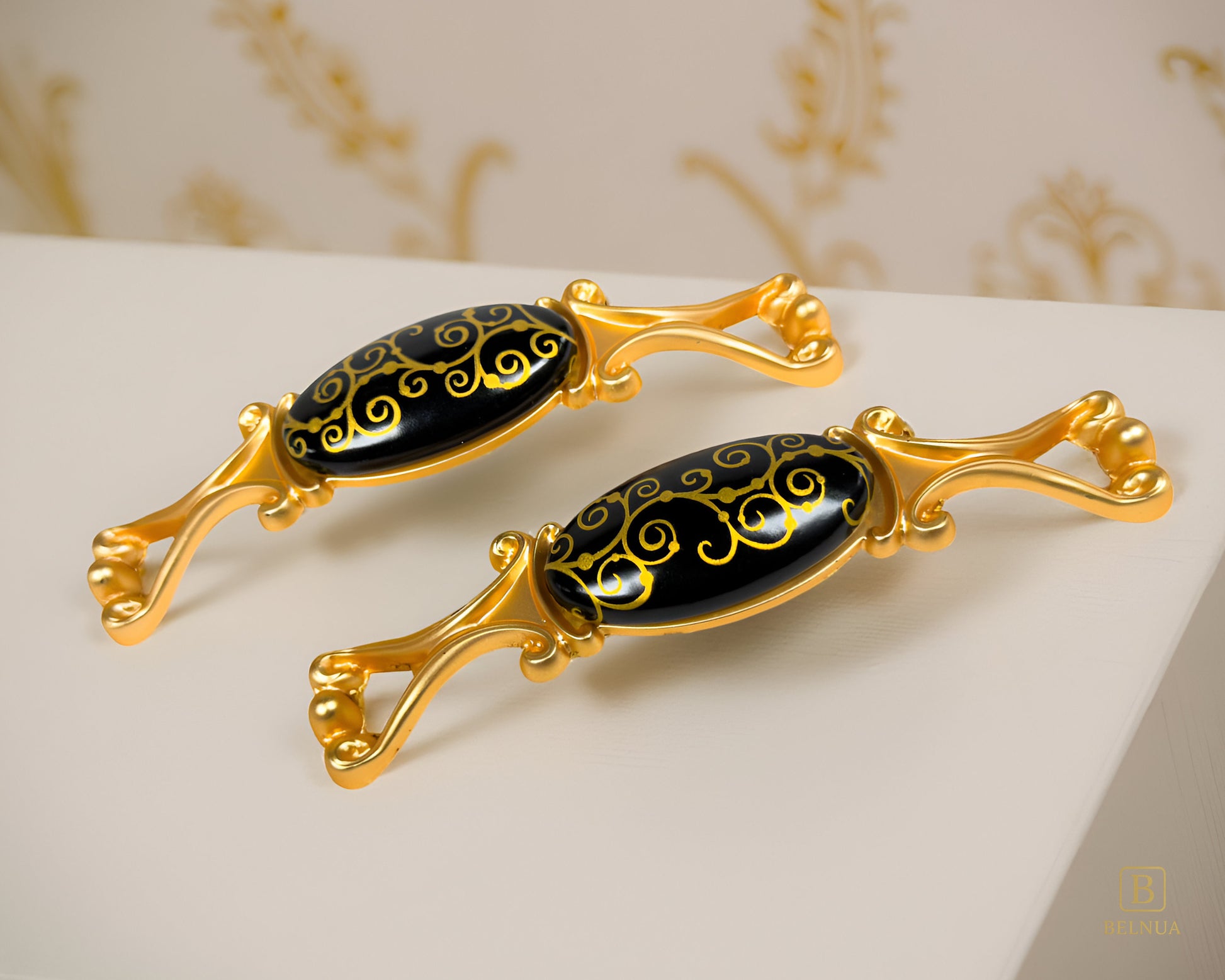 Belnua- Two decorative Nureya pulls with gold frames and black porcelain with golden scroll motif with marble and floral background