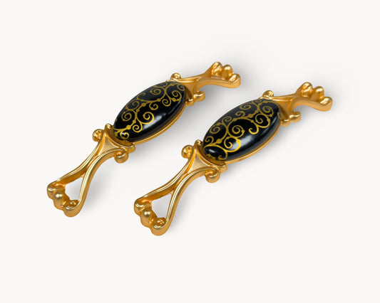 Belnua- Two decorative golden scroll motif handles with gold frames and black porcelain from Nureya collection