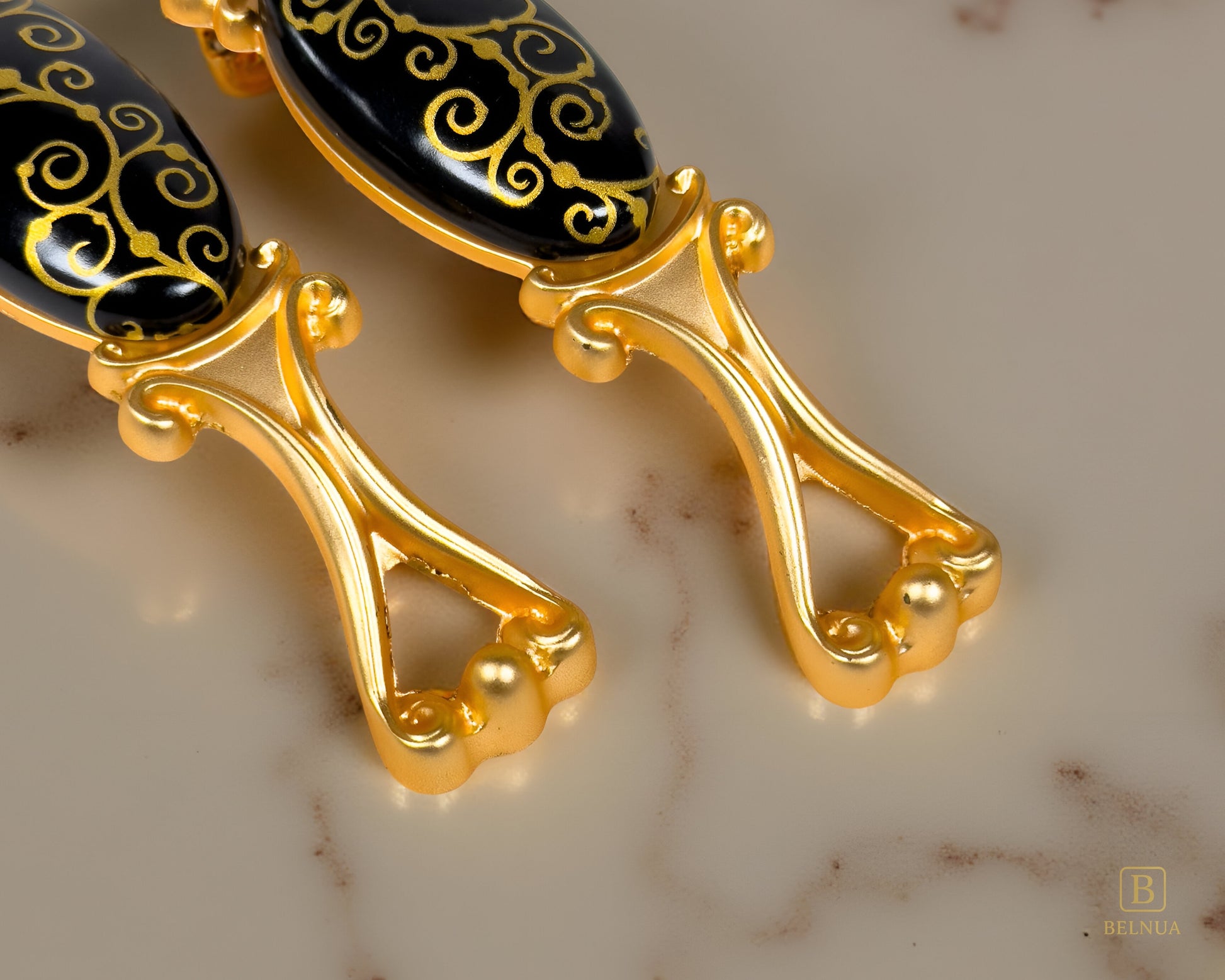 Belnua - Closeup view of Nureya gold cabinet handle base pairs with light brown marble worktop