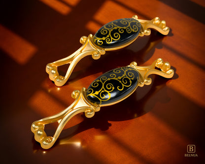 Belnua - Under shadow view of Nureya cabinet handle pairs with black porcelain featuring scroll motif with walnut background