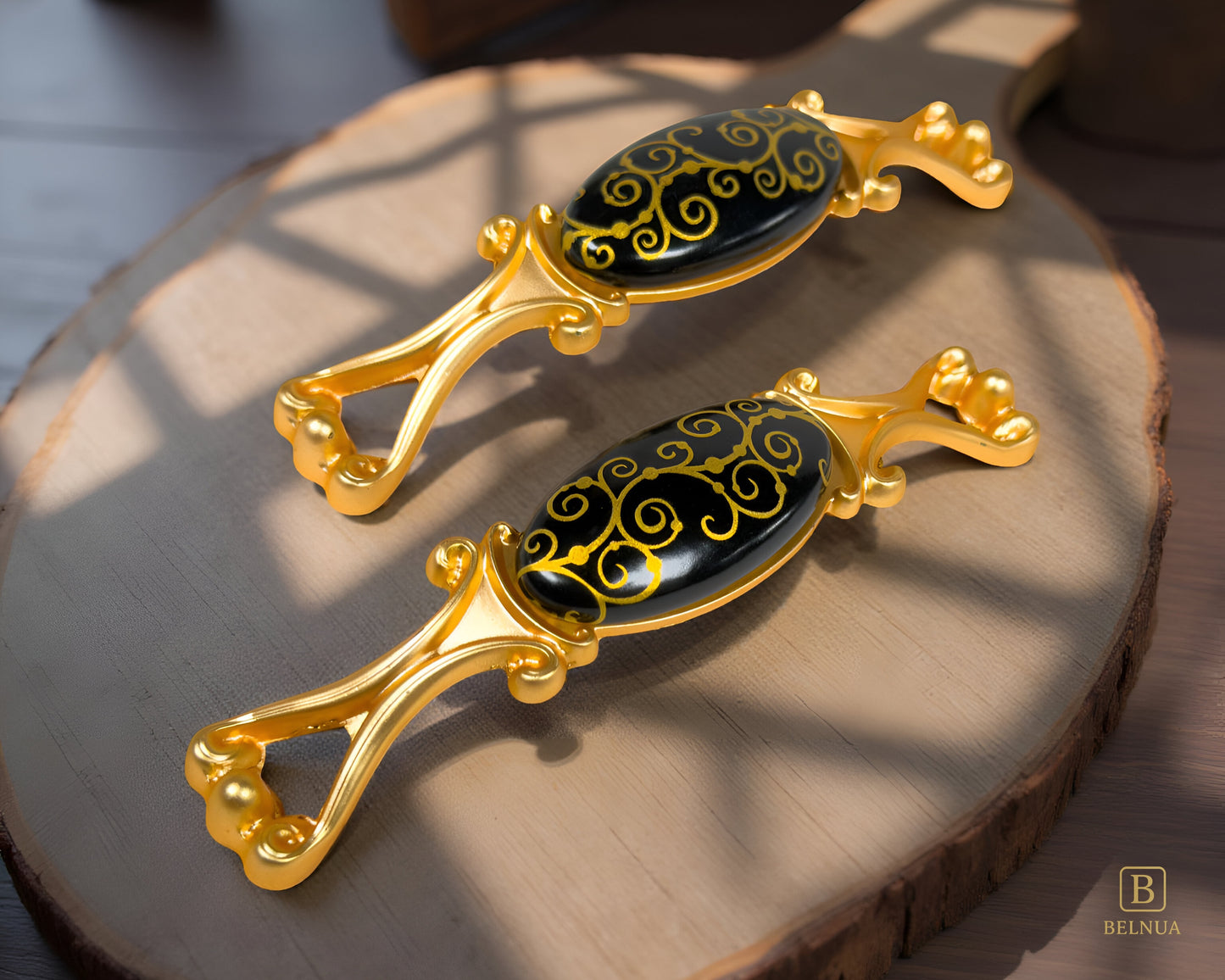 Belnua - Top view under shadows of Nureya gold cabinet handle pulls with black porcelain/ceramic with kitchen chopping wood background