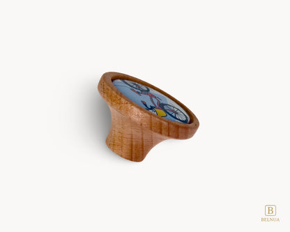 Belnua - Back angled view of dreamy Nuvino children knob with oak wood base and bicycle design ceramic insert for boys, girls, nursery, teens room and furniture