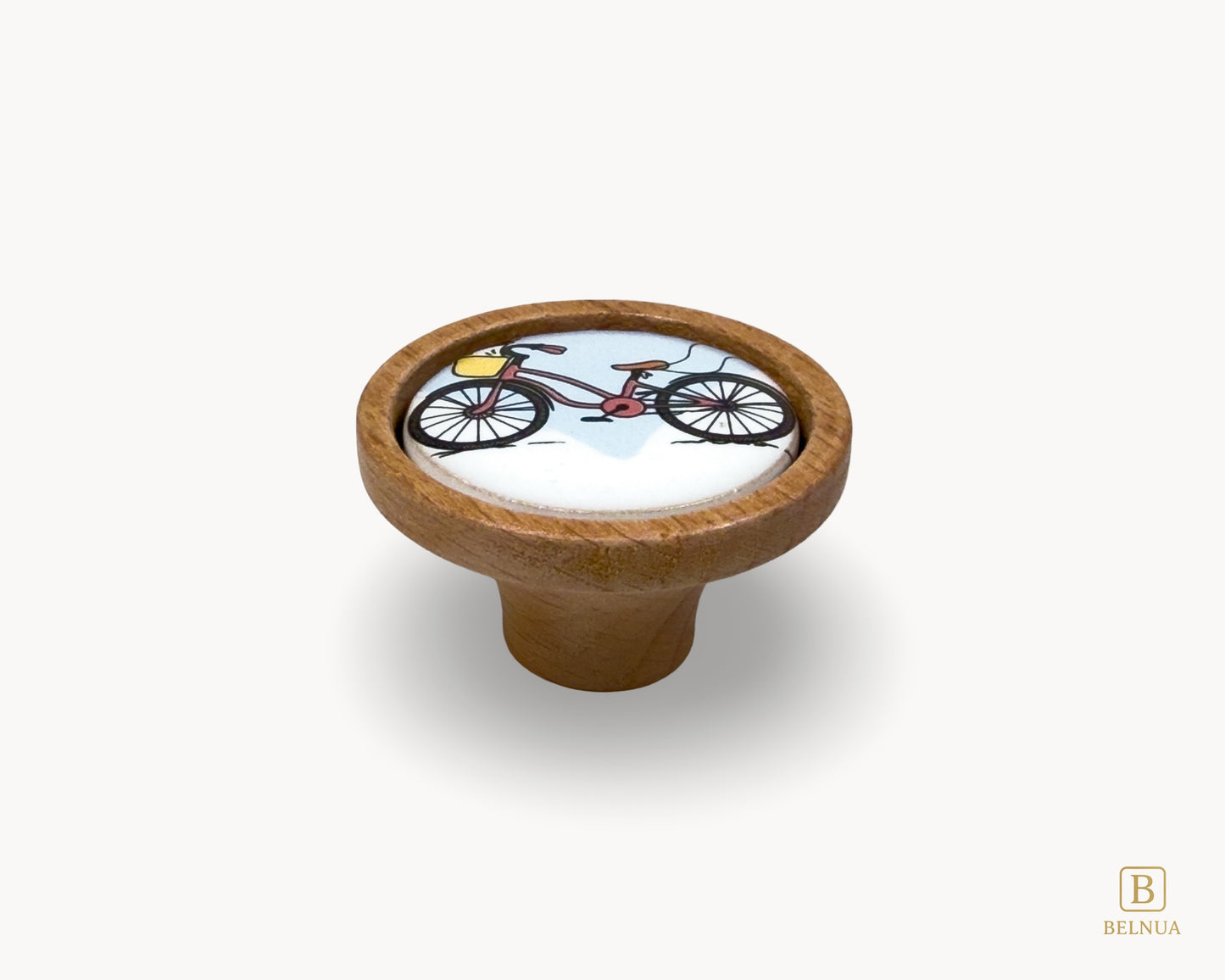 Belnua - Front flatlay view of delicate Nuvino children knob with oak wood base and bicycle design porcelain insert for boys, girls, nursery, teens room and furniture