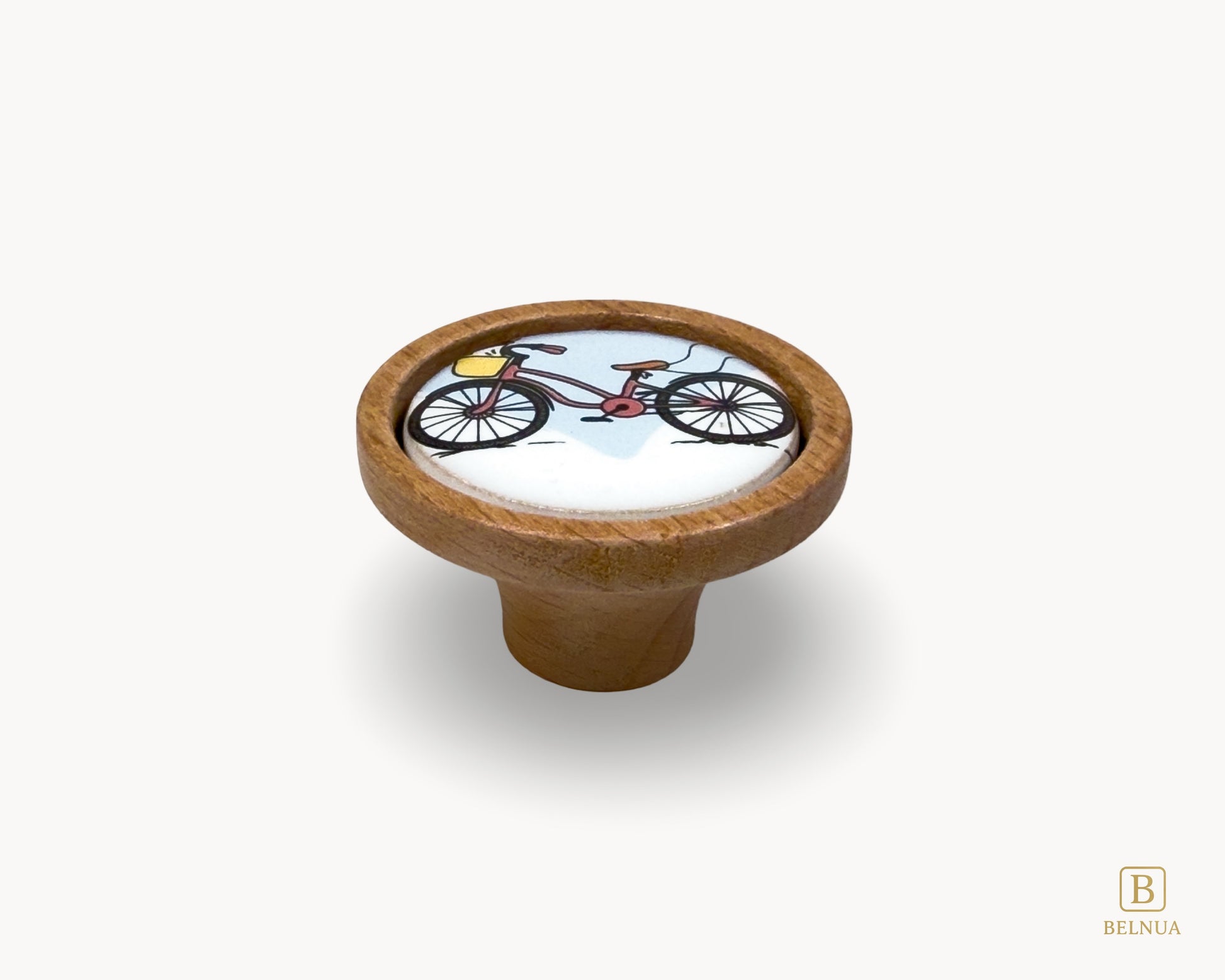 Belnua - Front flatlay view of delicate Nuvino children knob with oak wood base and bicycle design porcelain insert for boys, girls, nursery, teens room and furniture