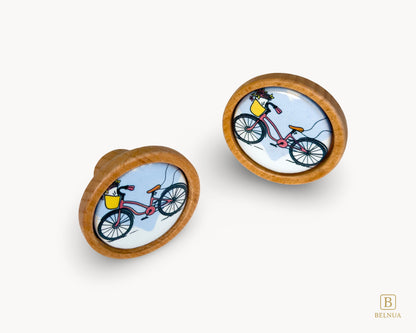Belnua - Front angled view of luxury Nuvino children knob pair with oak wood base and bicycle design porcelain insert for boys, girls, nursery, teens room and furniture