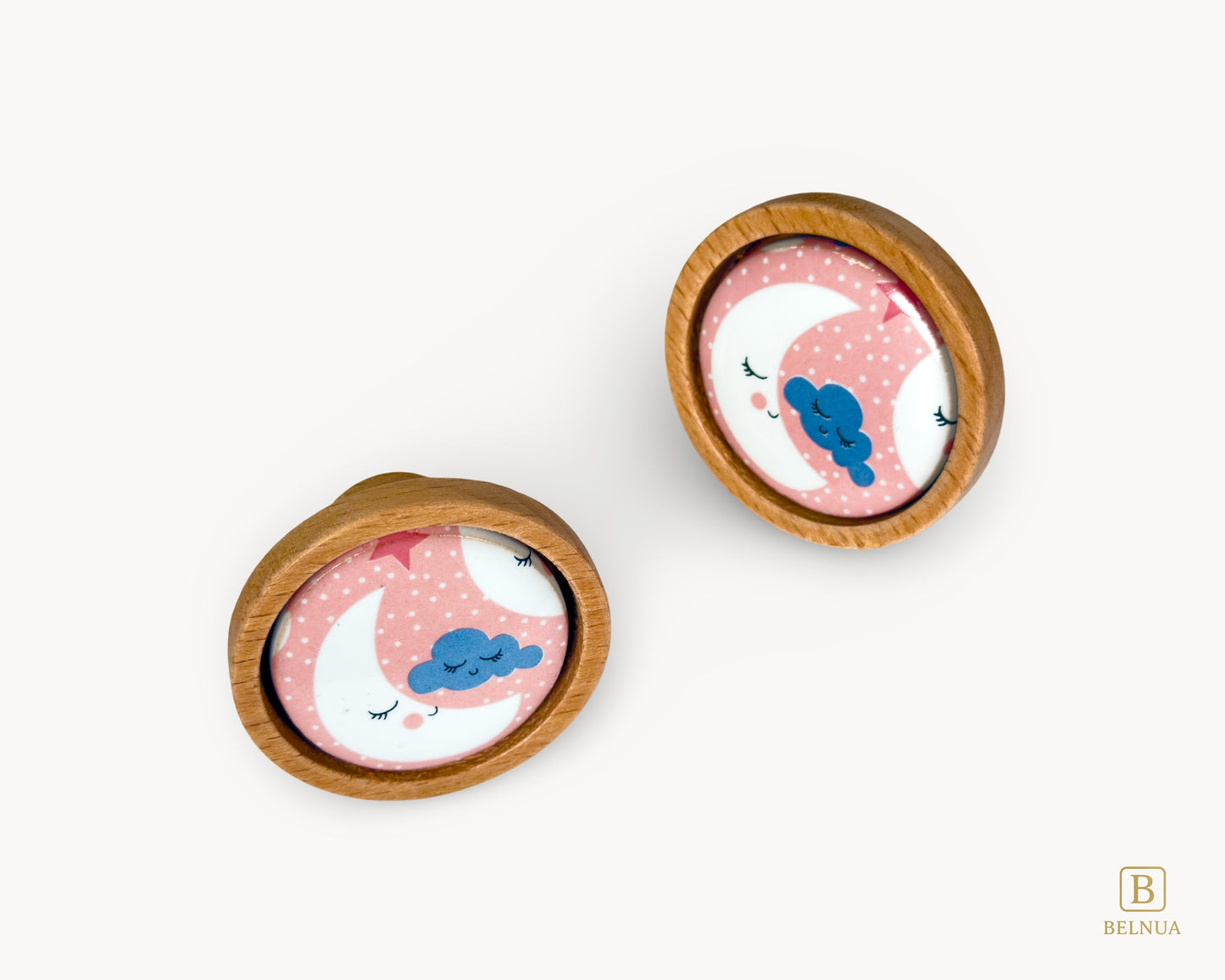 Belnua - Front angled view of delicate Nuvino children knob pairs oak wood and moon and star motif porcelain for nursery, children, teens, girls room and furniture