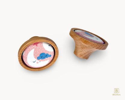 Belnua - Front and back angled view of delicate Nuvino children knob pairs oak wood and moon and star motif porcelain for nursery, children, teens, girls room and furniture