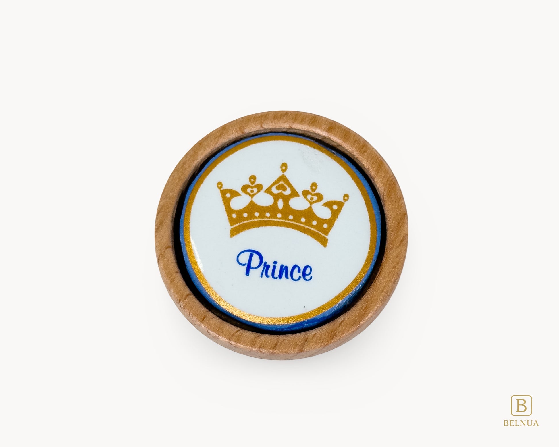 Belnua - Closeup top view of delicate Nuvino prince crown porcelain knob with oak wood base for boys, children, teens room