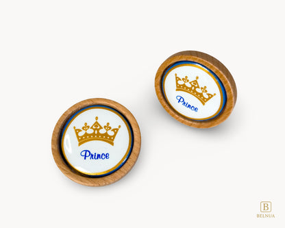 Belnua - Closeup top and angled front view of Nuvino prince crown porcelain knob pair with oak wood base for boys, children, teens room