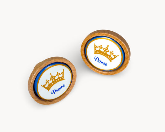 Front view of Belnua Nuvino knob pair with wood and white porcelain insert featuring princess design