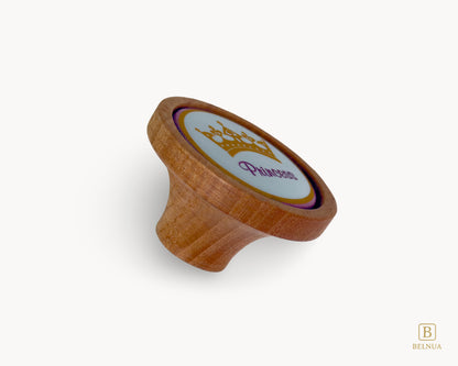 Belnua - side angled view of Nuvino oak wood knob with porcelain/ceramic insert with princes crown design for teens, girls, children, nursery rooms