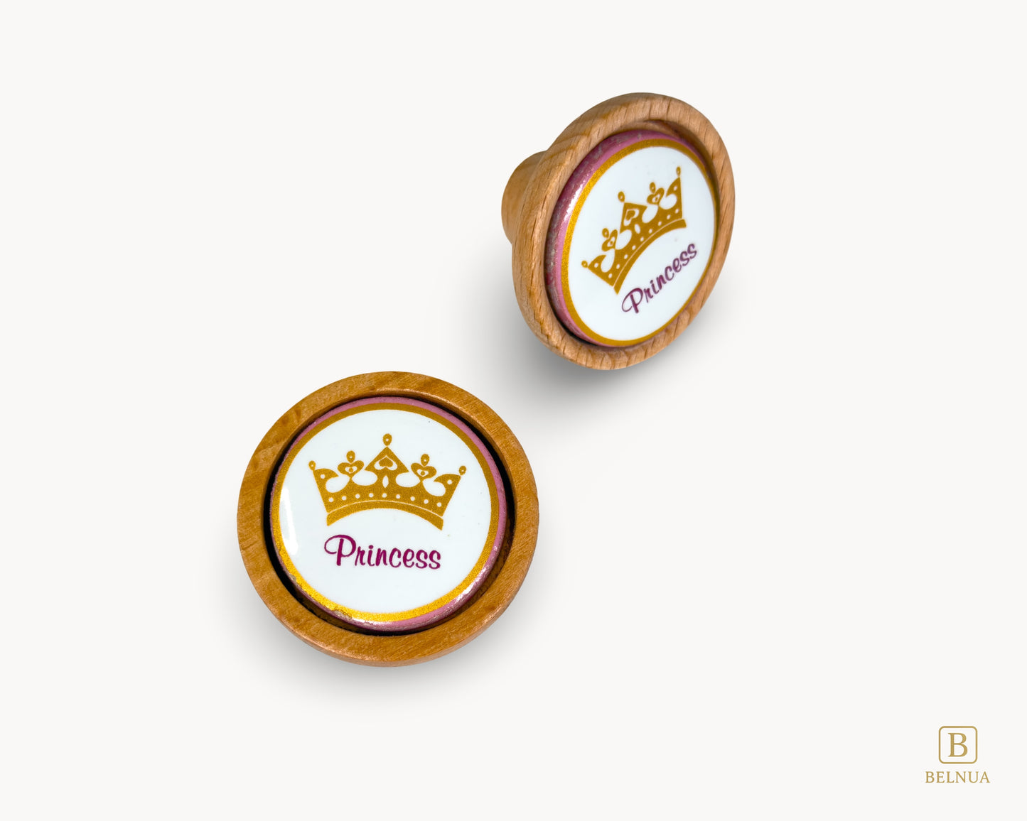 Belnua - Top and front right view of Nuvino wood knob pair with princes crown porcelain insert for girls, children rooms