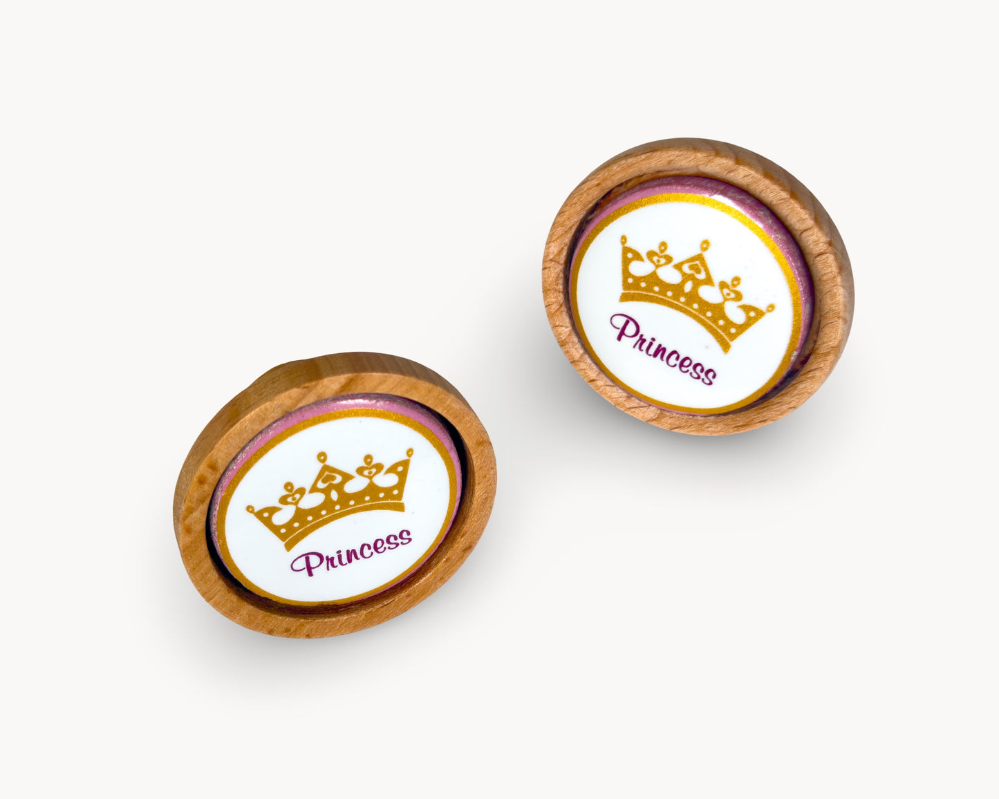 Front view of Belnua Nuvino knob pair with wood and white porcelain insert featuring princess design