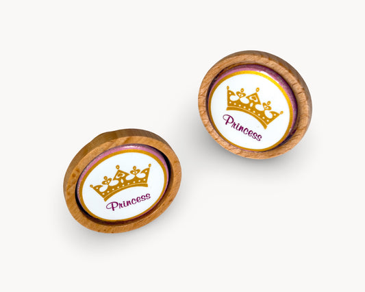 Front view of Belnua Nuvino knob pair with wood and white porcelain insert featuring princess design