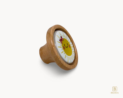 Belnua - Right angled view of luxury Nuvino children natural oak wood knob with delicate smiling sun porcelain design for girls, children, teens rooms & wardrobe and nursery and school play rooms.