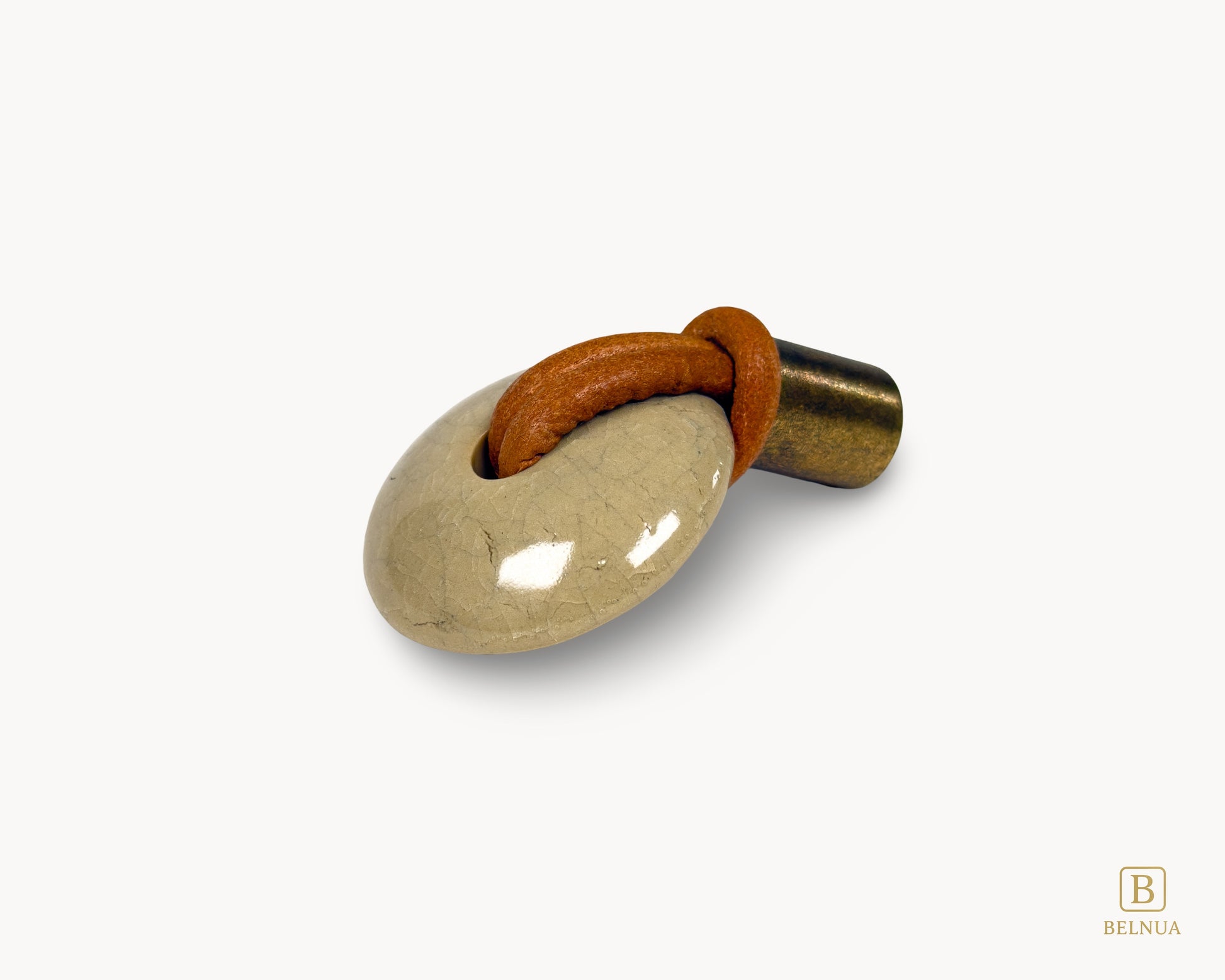 Right-angled view of REVINA porcelain cabinet knob showing curved ceramic body and leather detailing