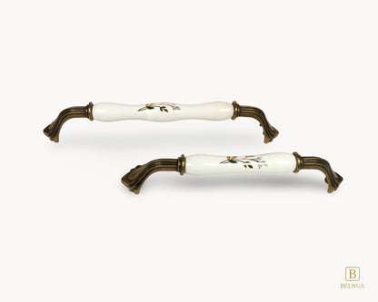 Belnua - Pair of Rosmira antique brass handle with white ceramic/porcelain know showing details of floral motif