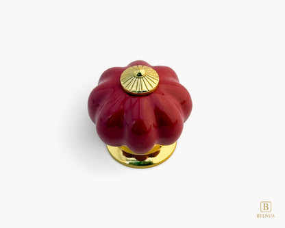 Belnua - Top view of Tavira cabinet porcelain knob in red colour with gold metal base in pumpkin shape