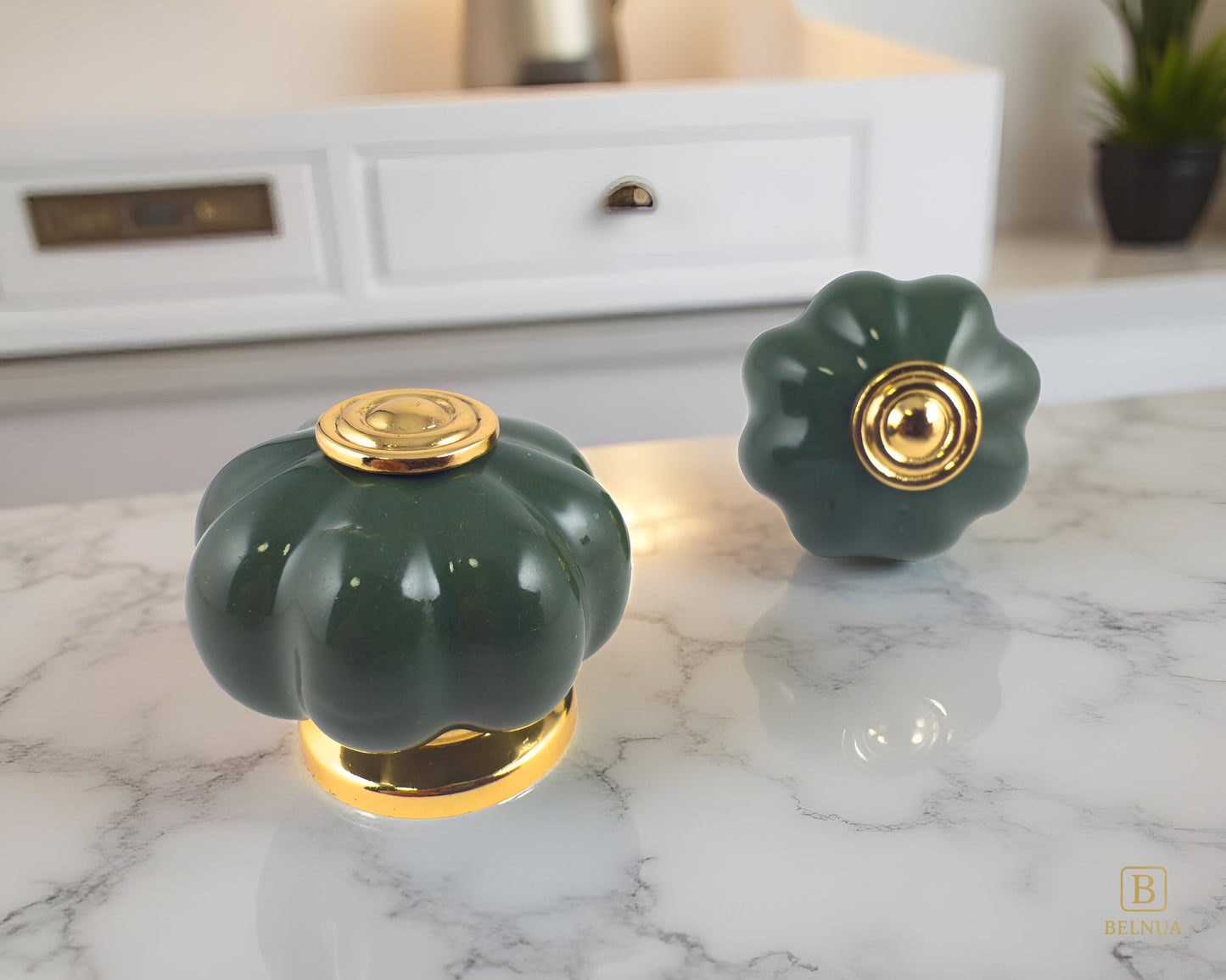 Belnua - Front and top view of Tavira gold base knob with dark green porcelain insert  for kitchen cabinets on marble worktop